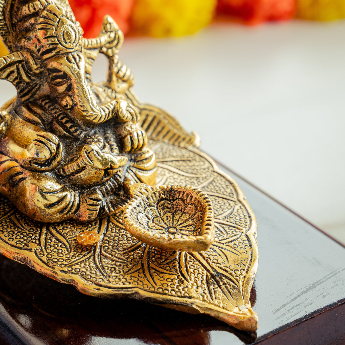 Brass Finish Ganesh Ji Sitting On Pan With Red Velvet Box