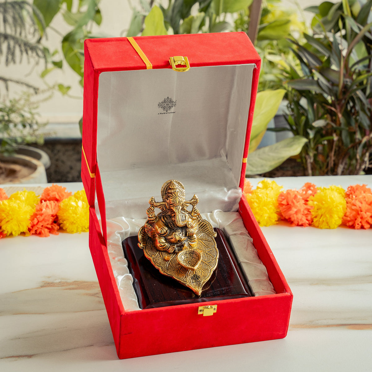 Brass Finish Ganesh Ji Sitting On Pan With Red Velvet Box