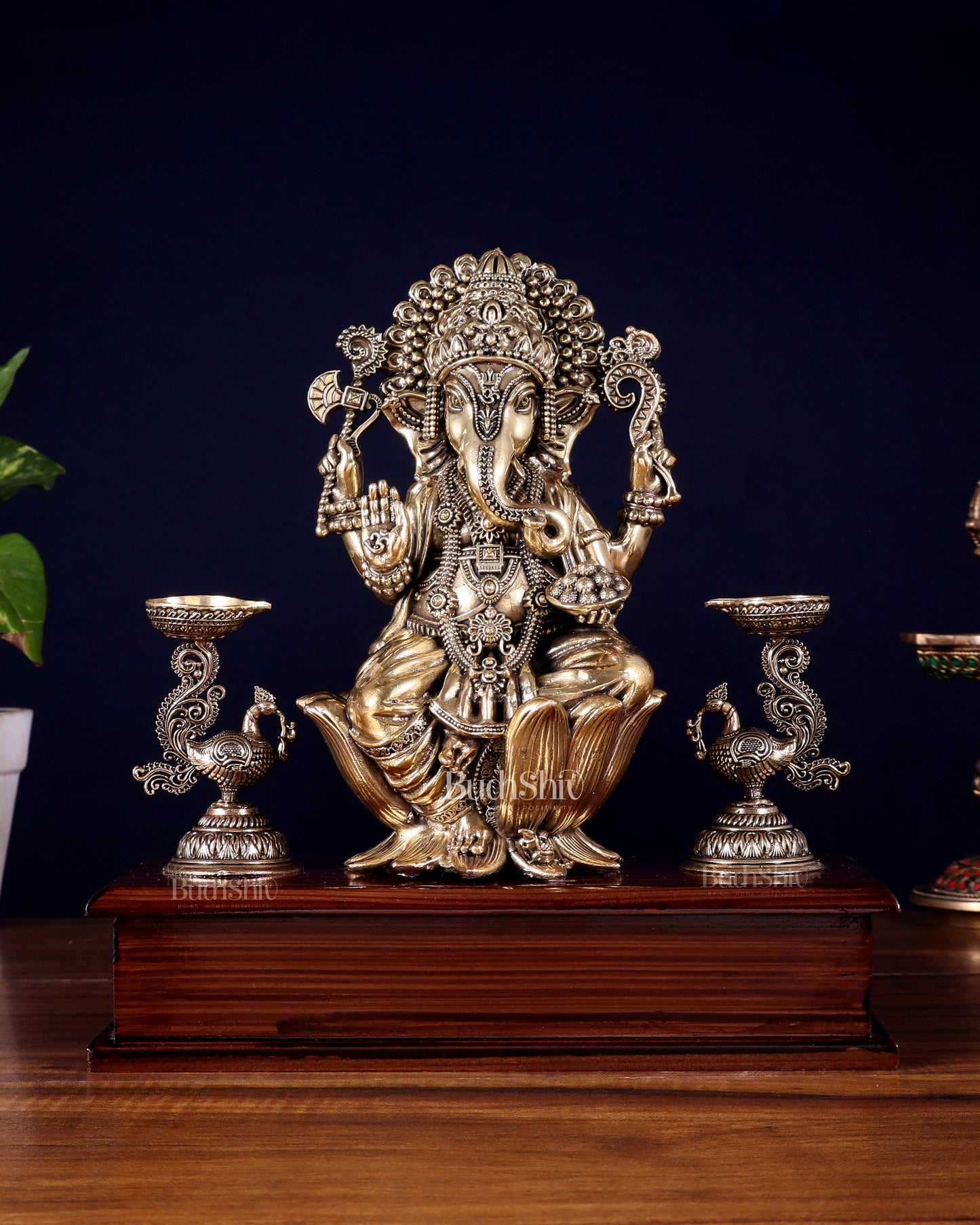 Brass Superfine Lord Ganesha Idol with Twin Peacock Lamps on Wooden Base – 9.5 Inch