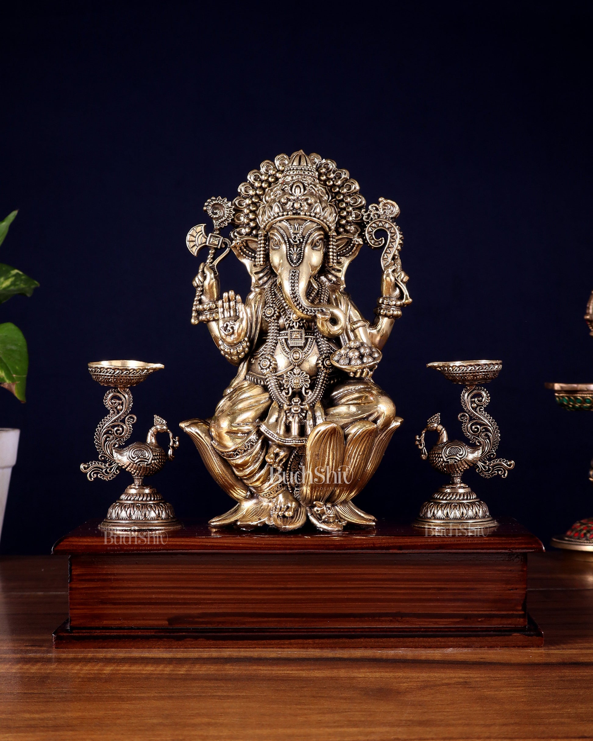 Brass Superfine Lord Ganesha Idol with Twin Peacock Lamps on Wooden Base – 9.5 Inch
