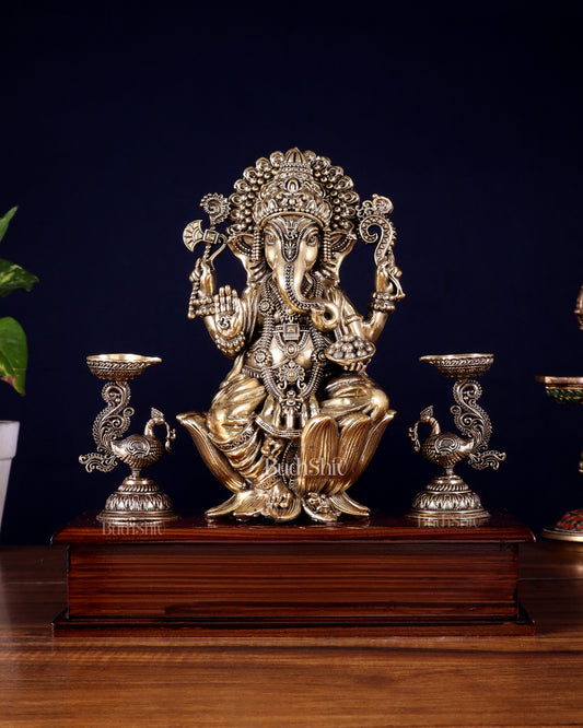 Brass Superfine Lord Ganesha Idol with Twin Peacock Lamps on Wooden Base – 9.5 Inch