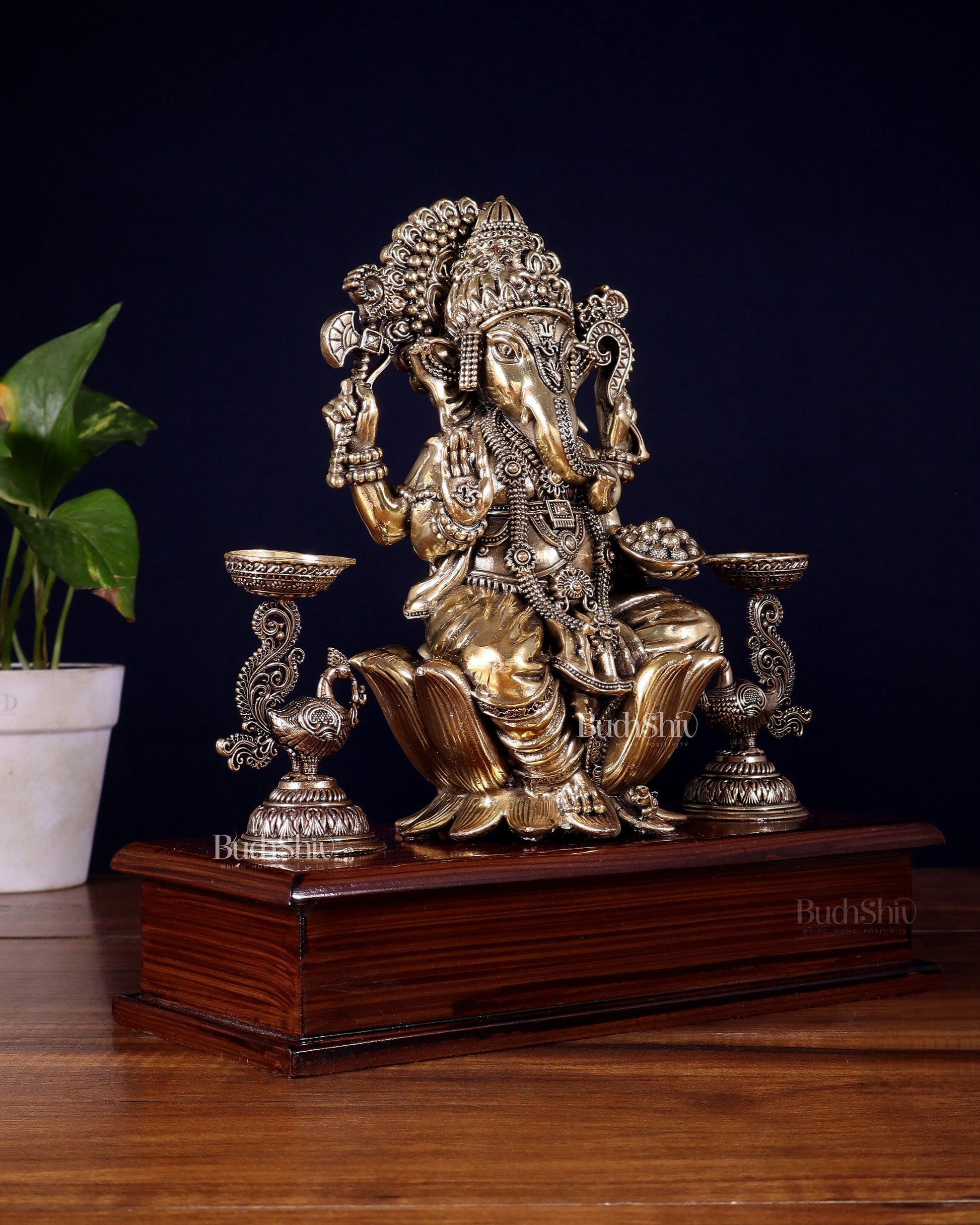 Brass Superfine Lord Ganesha Idol with Twin Peacock Lamps on Wooden Base – 9.5 Inch