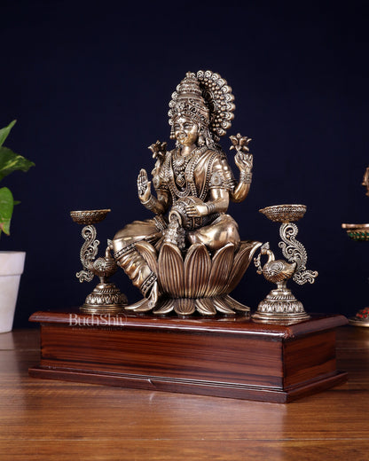 Brass Superfine Goddess Lakshmi Idol with Twin Peacock Lamps on Wooden Base – 9.5 Inch