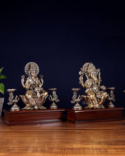 Brass Superfine Ganesh–Lakshmi Pair with Twin Peacock Lamps on Wooden Base – 9.5 Inch