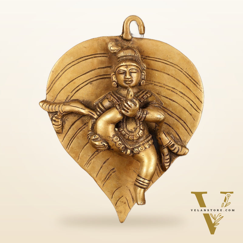 Brass Baby Krishna Baal Gopal Resting on a Leaf Hanging on Wooden Frame with Premium Fabric - 13" x 14"
