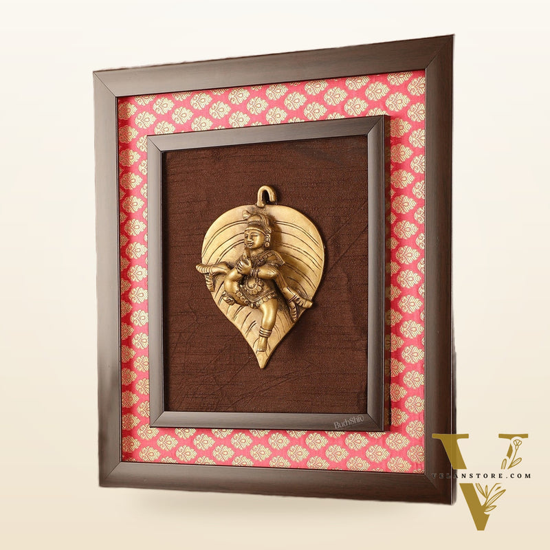 Brass Baby Krishna Baal Gopal Resting on a Leaf Hanging on Wooden Frame with Premium Fabric - 13" x 14"