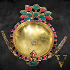 Brass peacock shaped urli with stonework