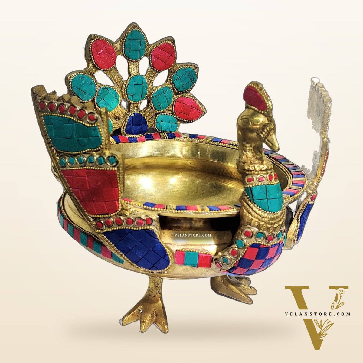 Brass peacock shaped urli with stonework
