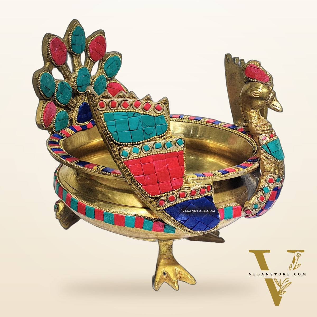 Brass peacock shaped urli with stonework