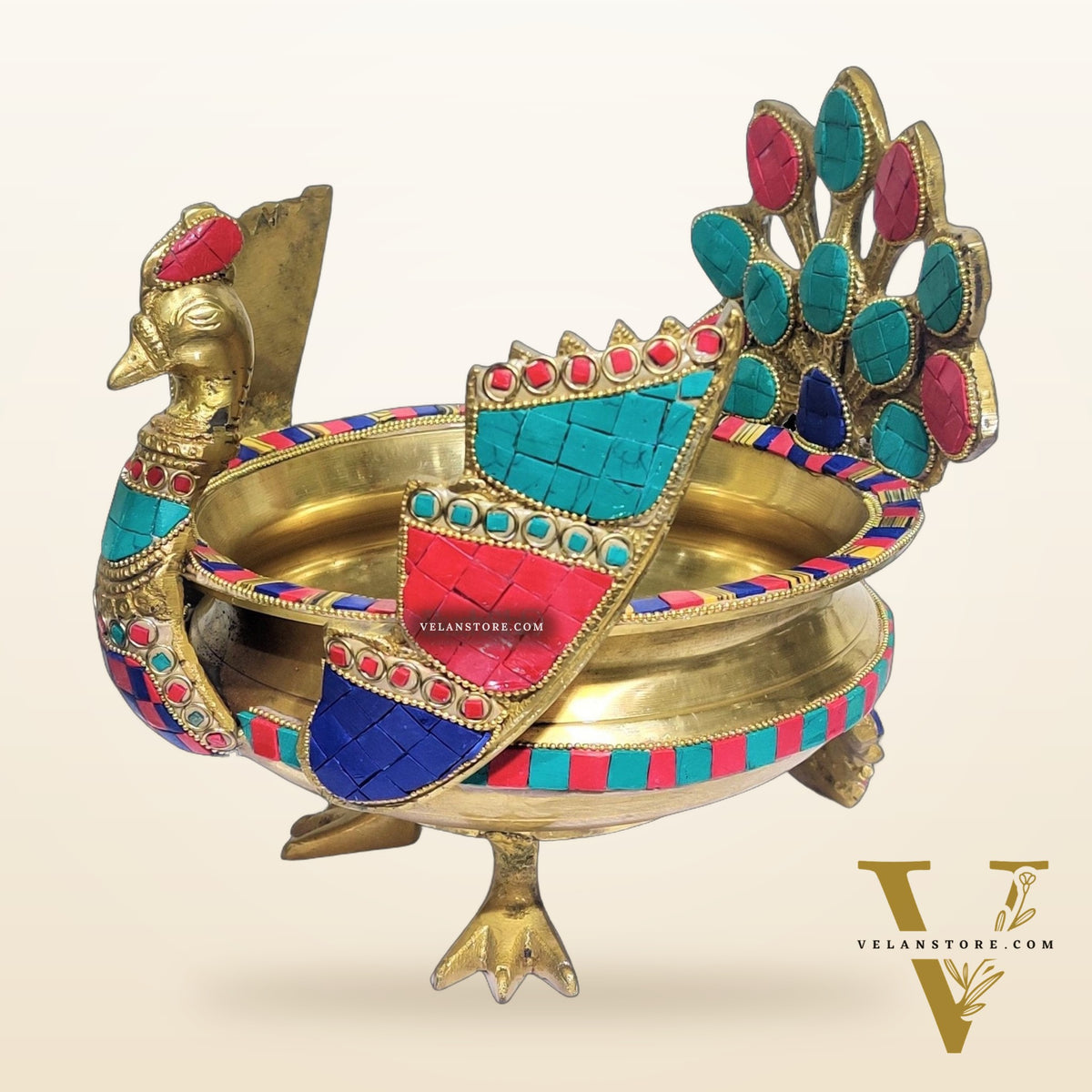 Brass peacock shaped urli with stonework