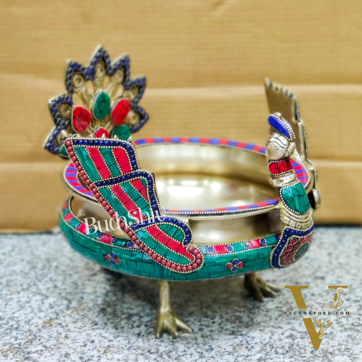 Brass peacock shaped urli with stonework