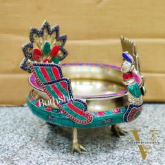 Brass peacock shaped urli with stonework