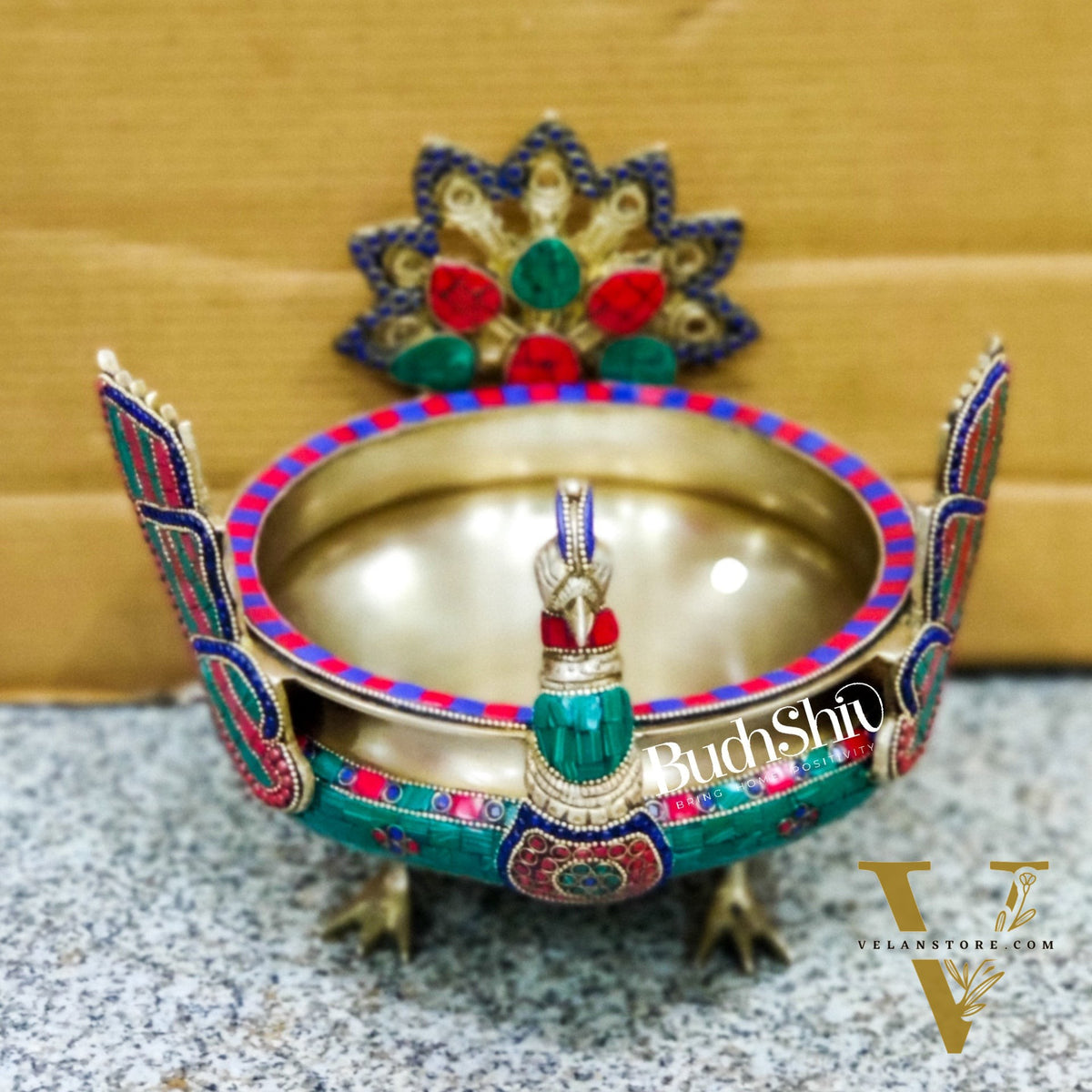 Brass peacock shaped urli with stonework