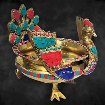Brass peacock shaped urli with stonework