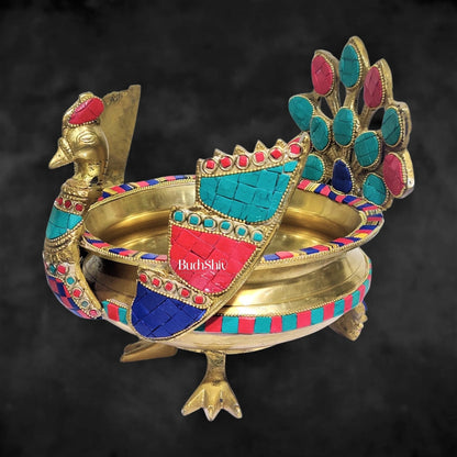 Brass peacock shaped urli with stonework