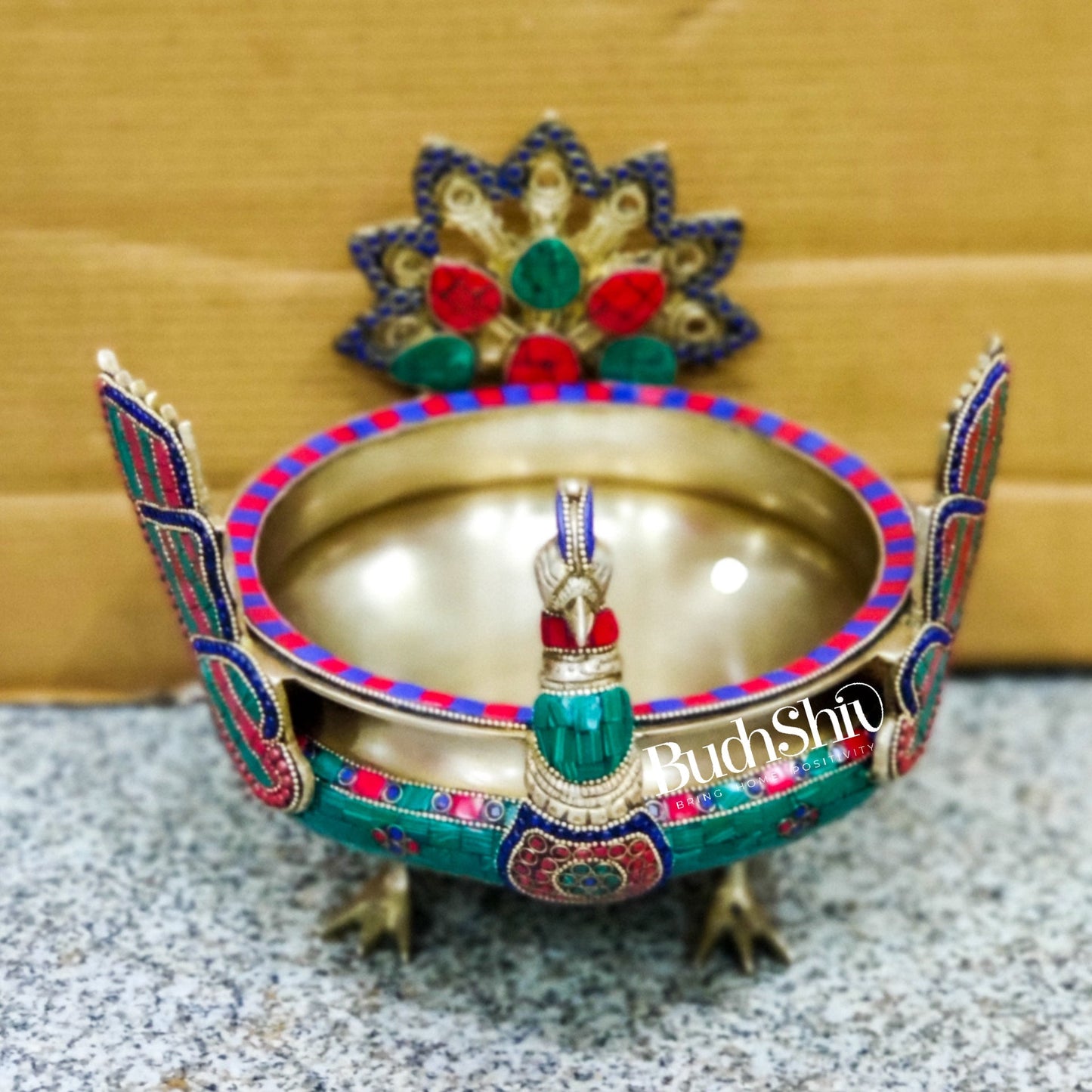 Brass peacock shaped urli with stonework