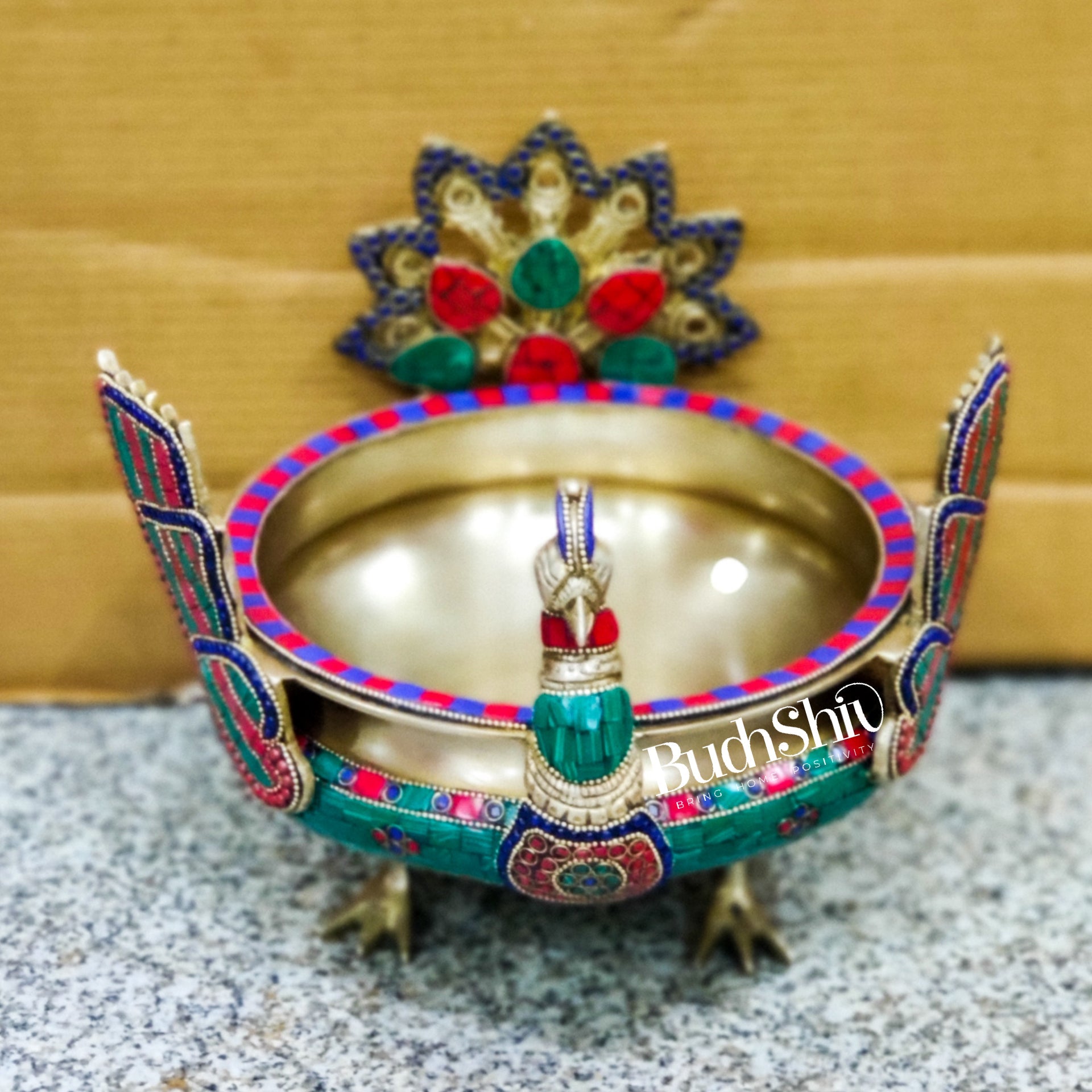 Brass peacock shaped urli with stonework