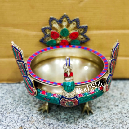 Brass peacock shaped urli with stonework