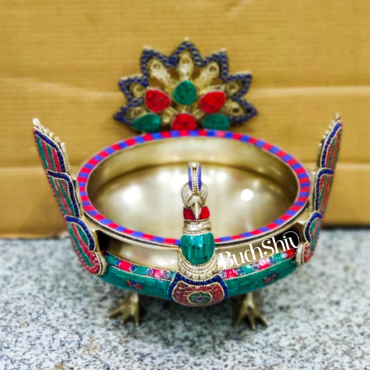 Brass peacock shaped urli with stonework
