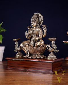 Brass Superfine Goddess Lakshmi Idol with Twin Peacock Lamps on Wooden Base – 9.5 Inch