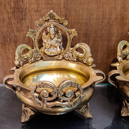 Divine Pair: Lord Ganesha and Goddess Lakshmi Brass Statues on Decorative Urli