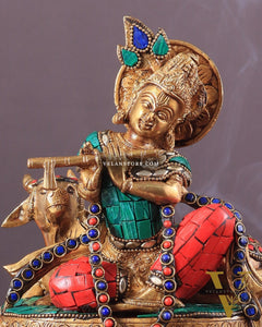 krishna seated with a cow on round base 7.5"