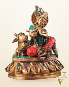 krishna seated with a cow on round base 7.5"